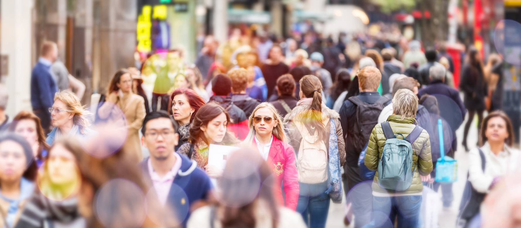 Crowd of people walking down a high street