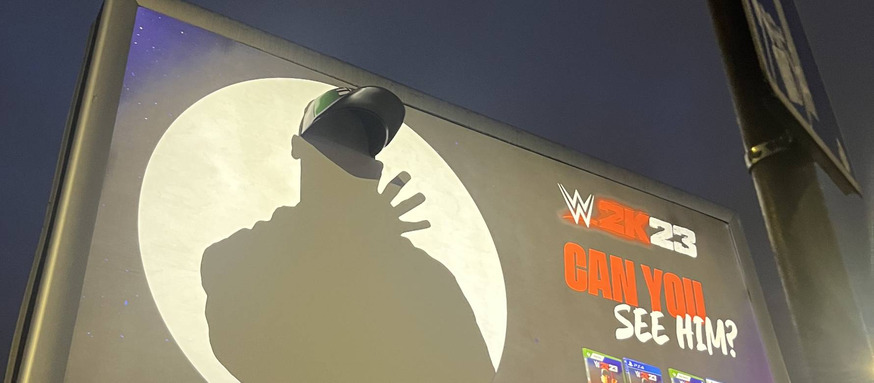 Special build billboard of WWE video game showing a person in silhouette