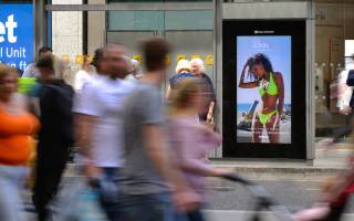 Digital screen on a bus stop showing Boux Avenue