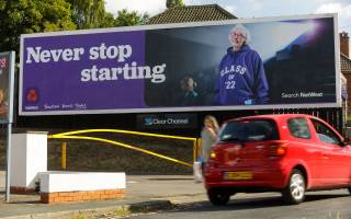 Natwest advert on large roadside billboard featuring an older lady in a hoody saying Never Stop Starting