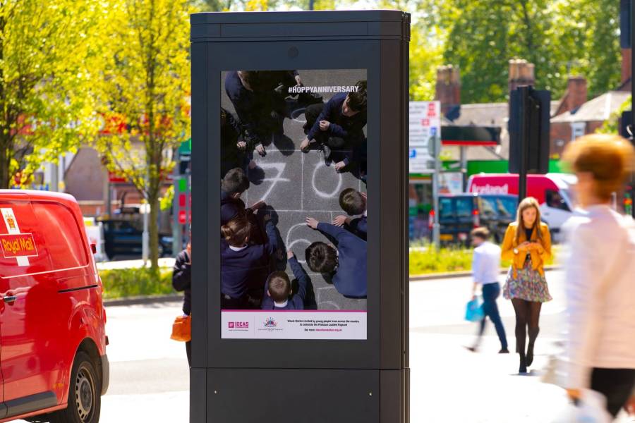 Digital screen on the high street showing Ideas Foundation ad