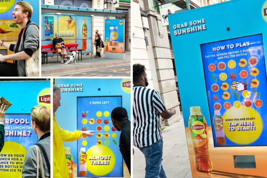 People interacting with a Lipton Out of Home advert featuring a touch screen game