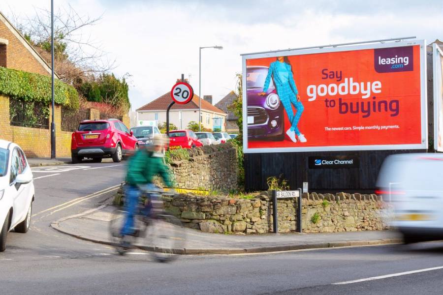 Billboard image displaying woman on a car, text saying 'Say goodbye to buying'