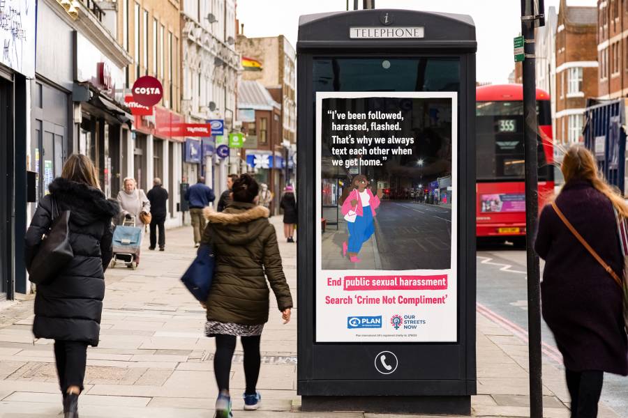 Digital phone box screen showing ad for Plan International UK