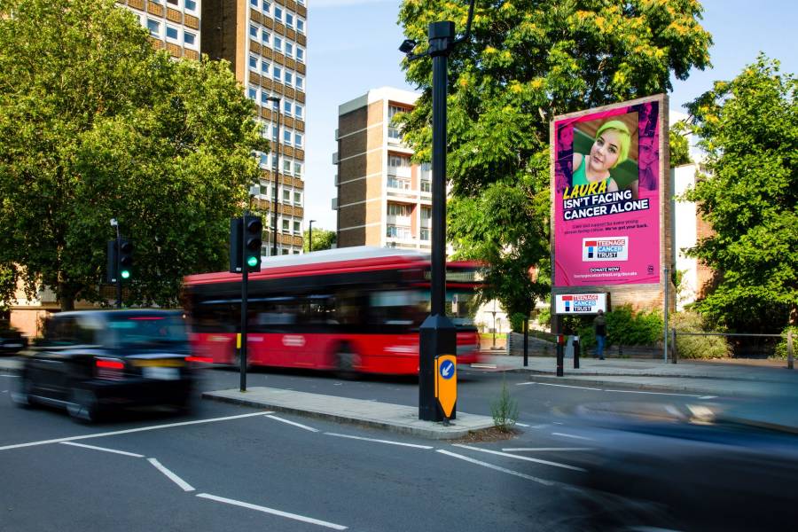 Large billboard on a busy main road showing Teenage Cancer Trust ad