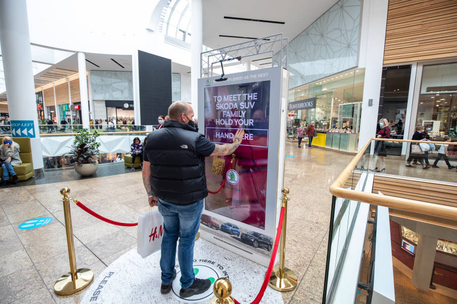 Digital screen in a busy shopping mall outside Beaverbrooks showing Skoda advert