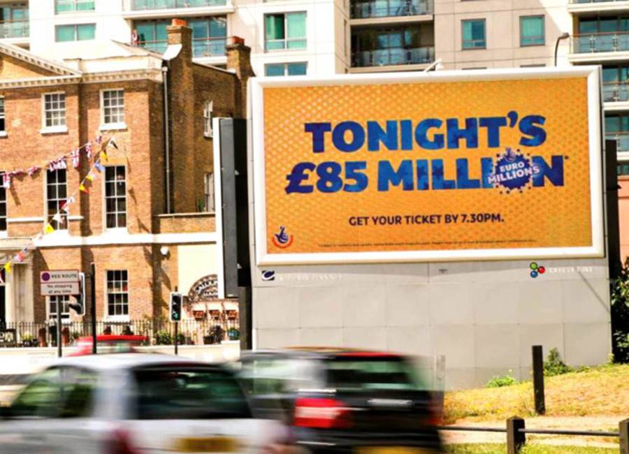 Large billboard showing ad for National Lottery