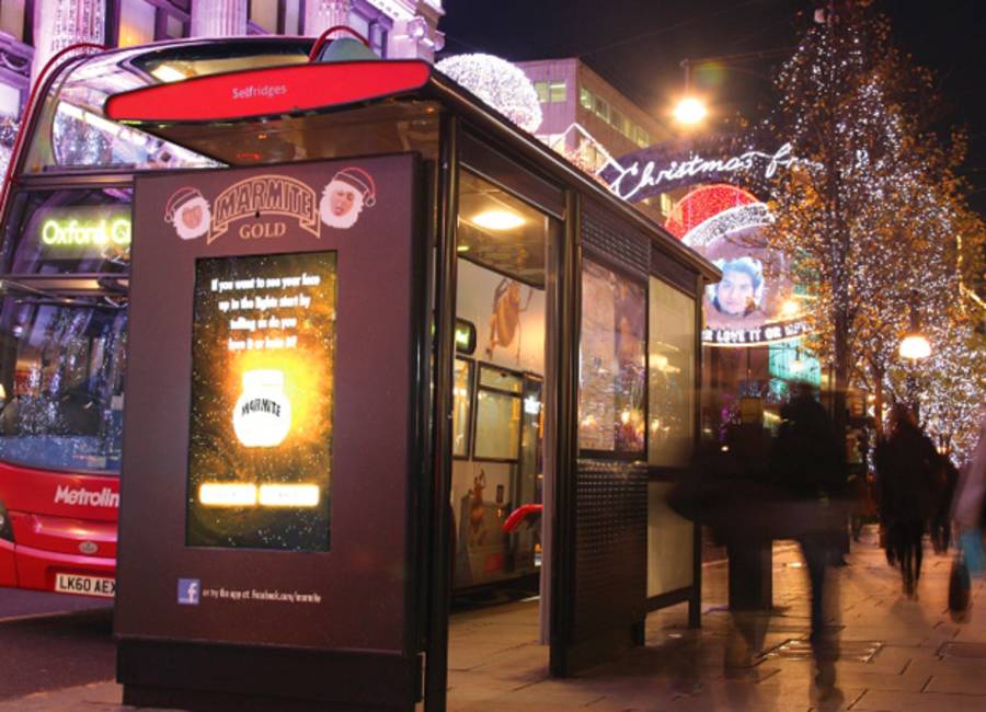 Digital screen on a bus stop showing Marmite ad