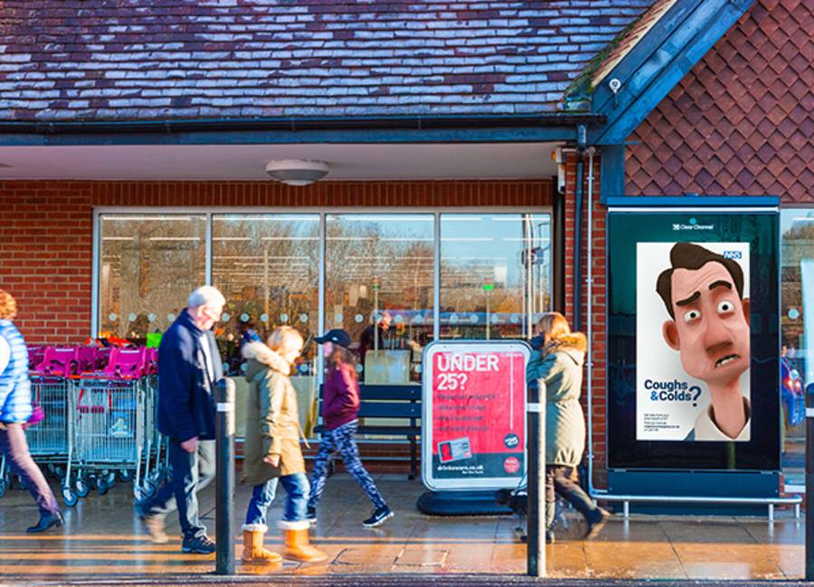 Supermarket digital screen in the rain featuring a cough & cold ad