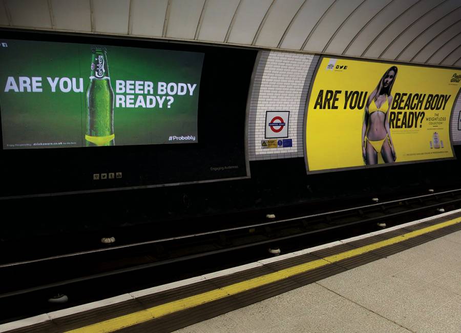 Liverpool Street underground platform showing ads for Carlsberg & Protein World