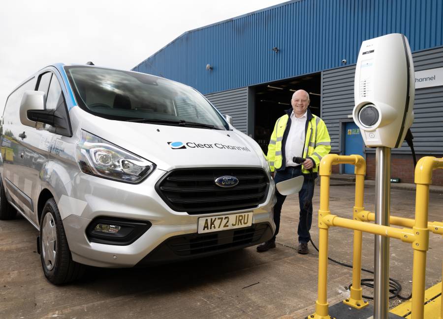 One of our operatives standing next to a Ford hybrid vehicle.