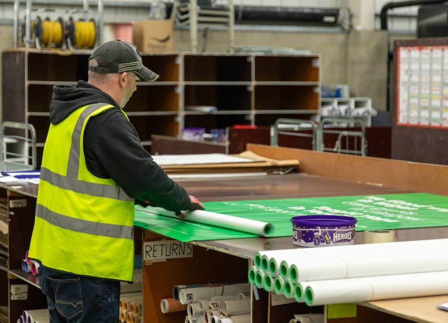 A operative inside our Dartford depo working on a Adshel poster.