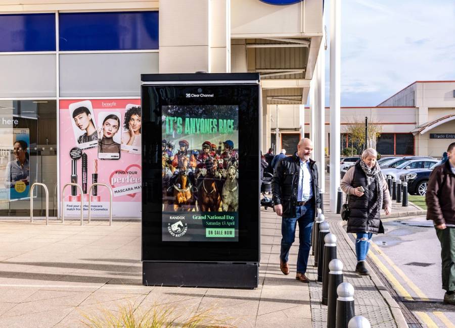 Grand National advert displaying on a digital screen outside of Boots