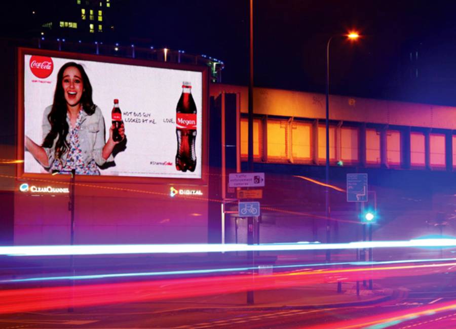Large billboard showing ad for Coca Cola