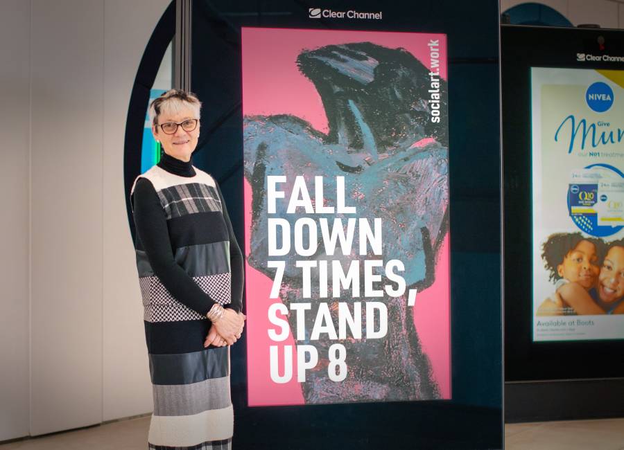 Rebecca Salter, President Royal Academy of Arts, stands in front of a digital screen displaying her quote and artwork by Martin Firrell, at Clear Channel's HQ in London