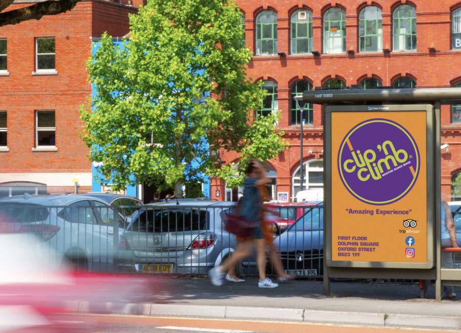 Clip 'n Climb's local bus stop ad with people walking past