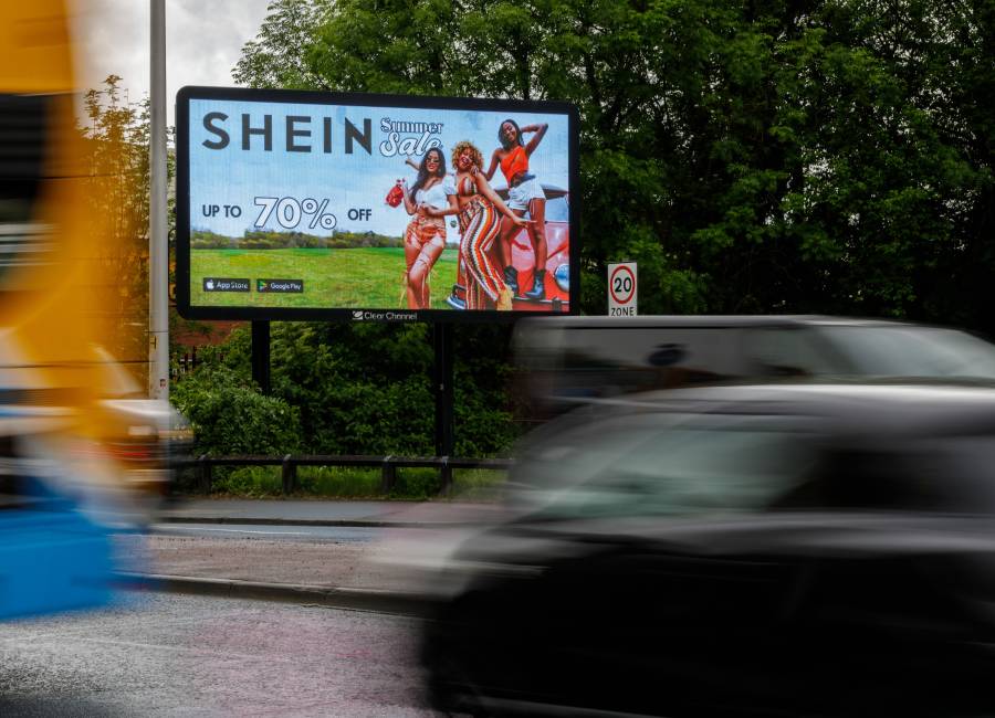 Shein's 'Summer sale' Billboard Live advertisement surrounded by lots of cars