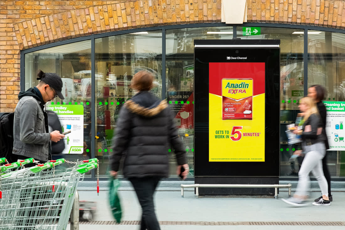 An Anadin Extra advert on a digital Asda Live screen outside of the Asda storefront