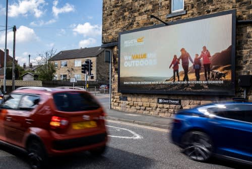 Roadside digital billboard with passing traffic