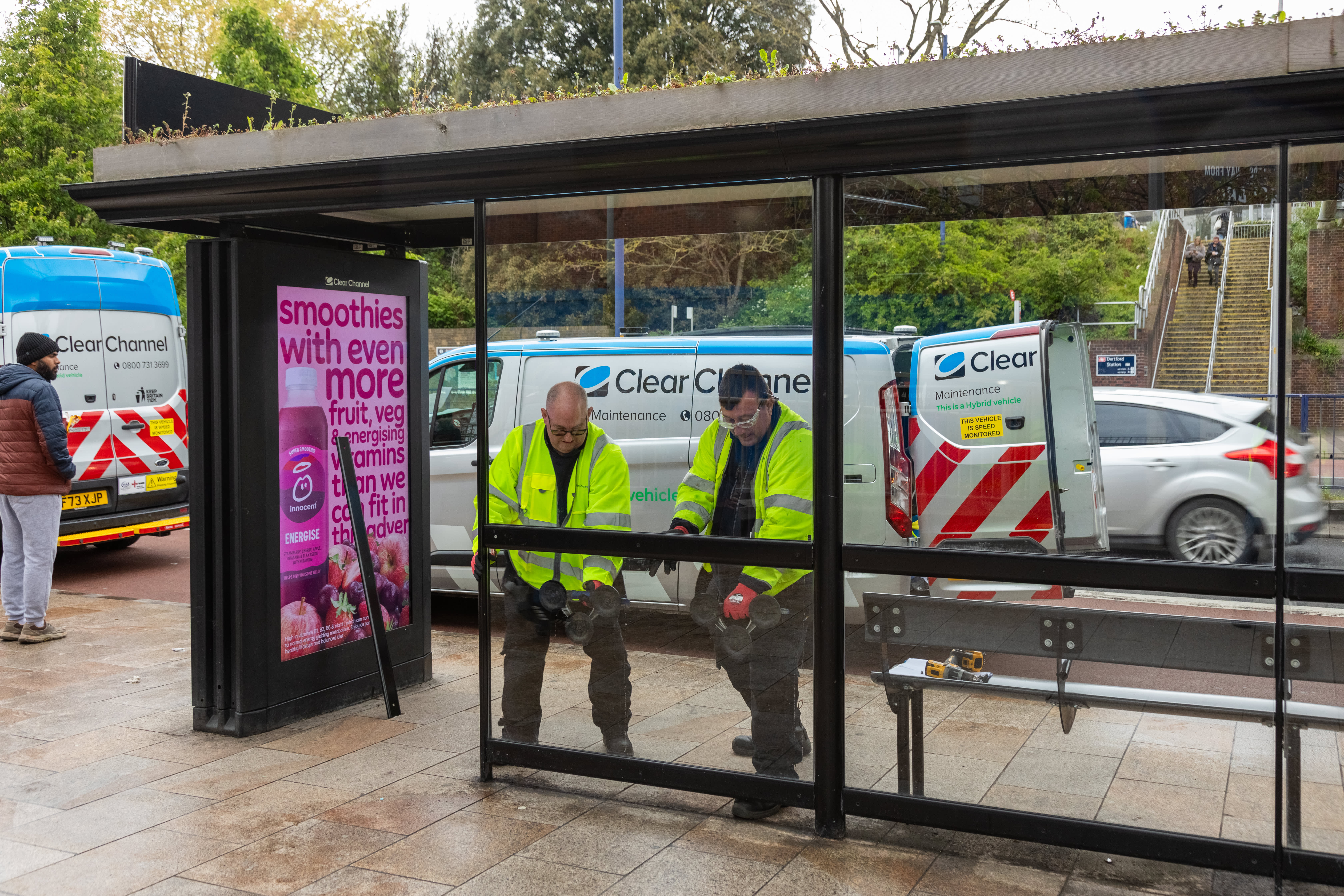 Operatives working on a bus shelter.