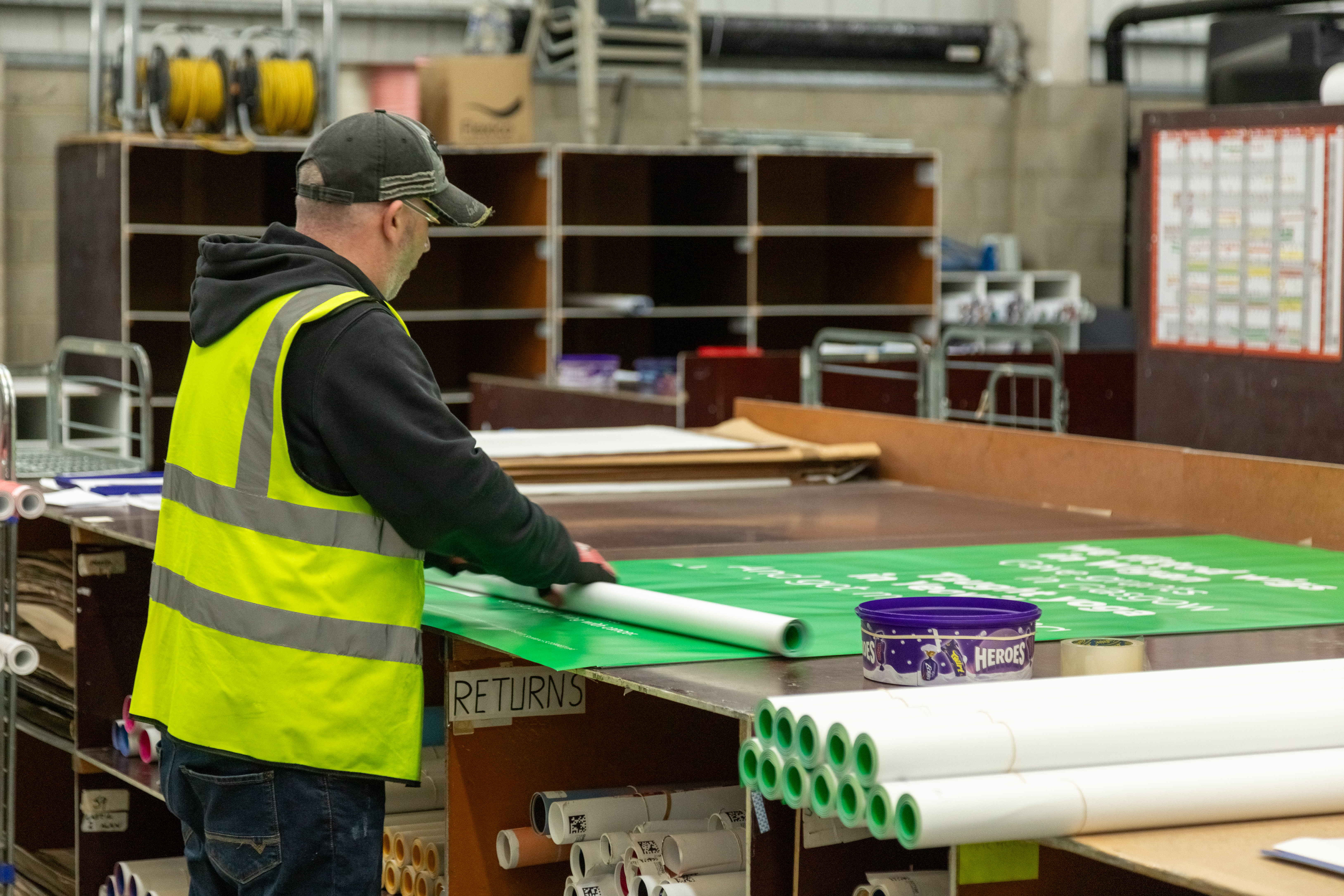 A operative inside our Dartford depo working on a Adshel poster.