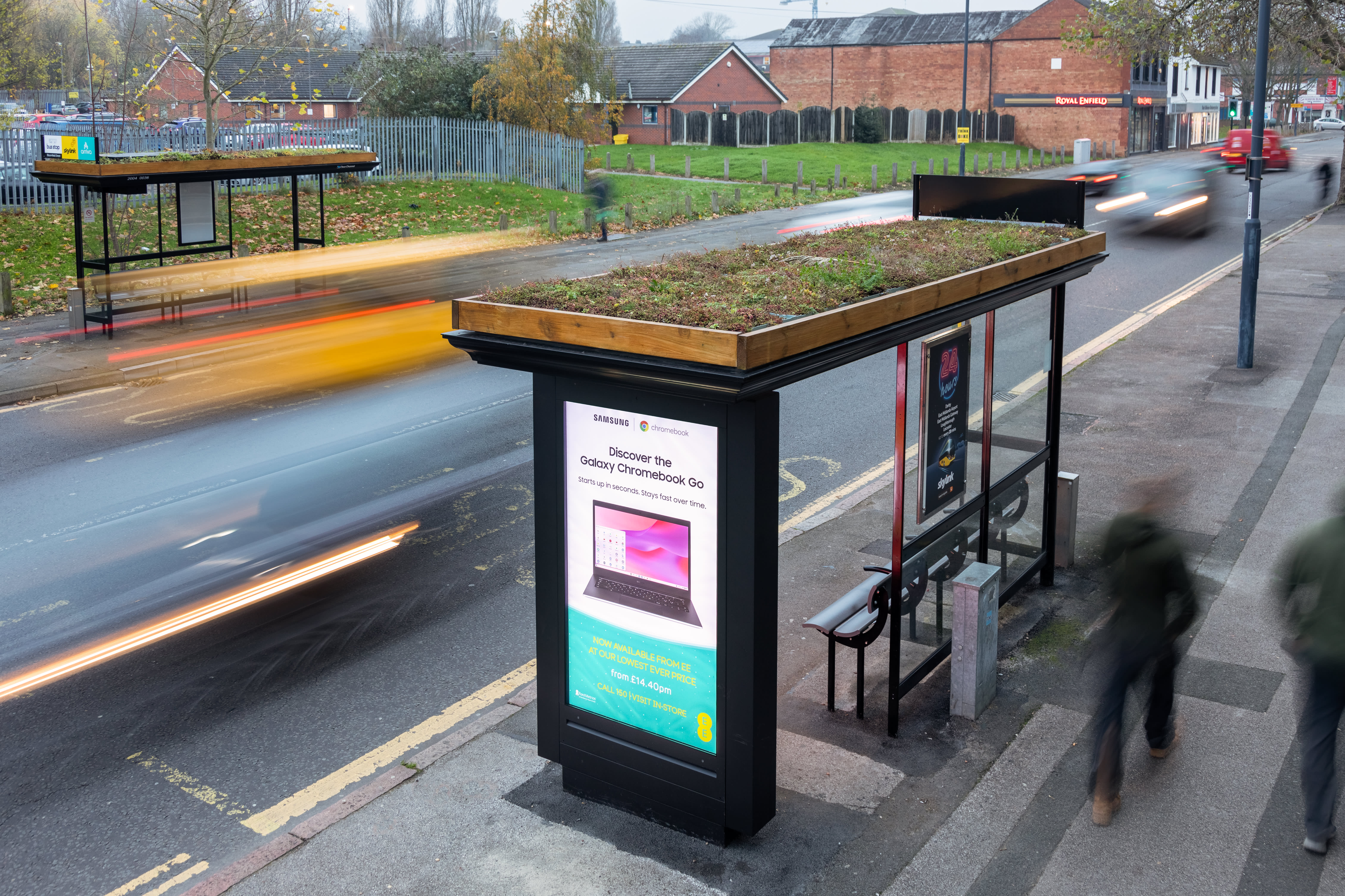 Digital screen on a bus stop with living roof showing ad for EE Samsung Galaxy Chromebook