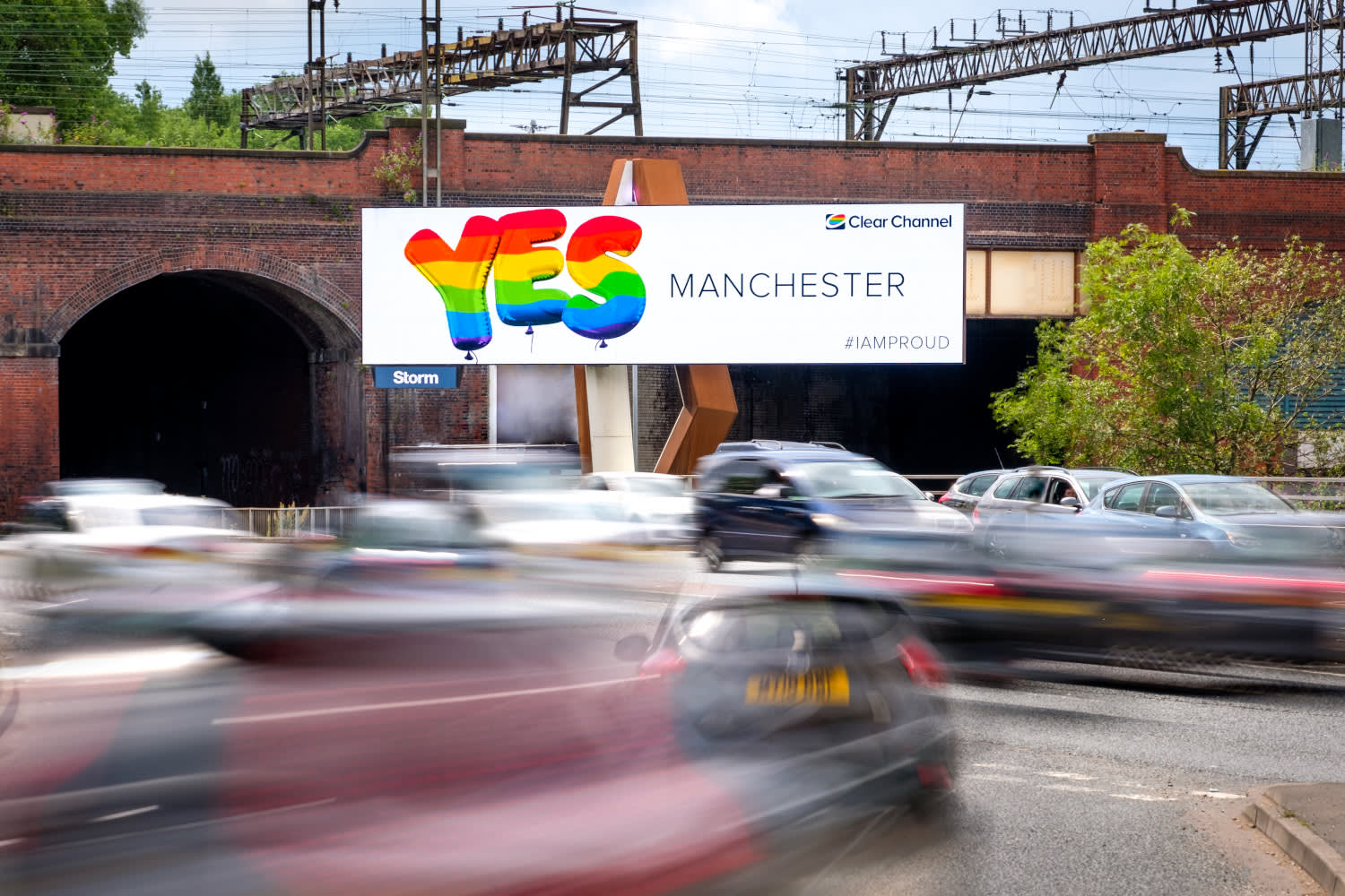 Clear Channel Strom site on a busy road showing ad for Manchester Pride