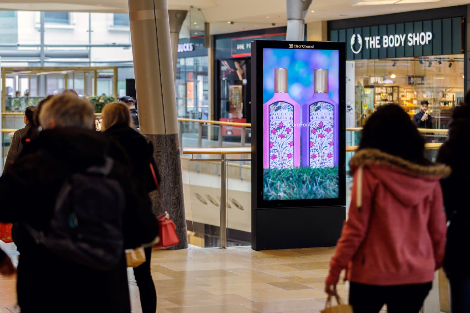 Gucci flora advert displaying on a digital Malls Live screen outside of retail stores.