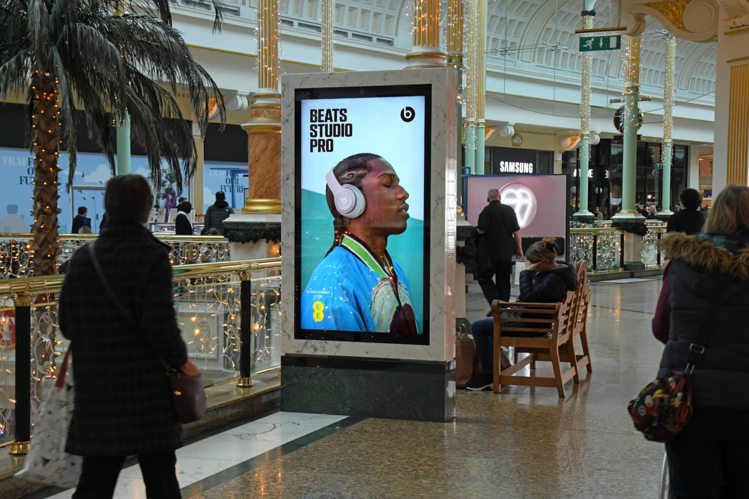 Digital screen in a shopping mall showing ad for Dr Dre Beats Studio Pro