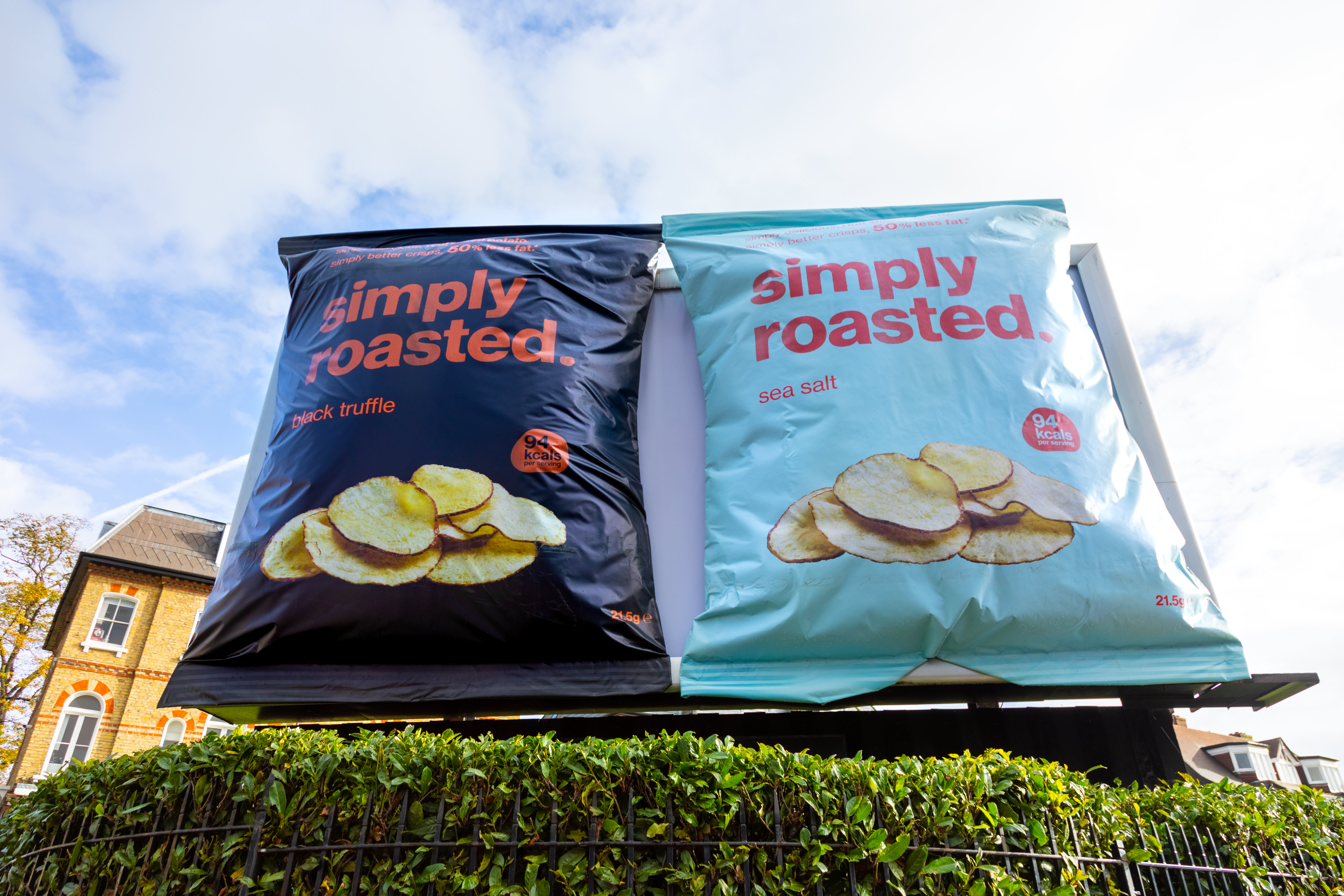 Clear Channel special build billboard showing two large packets of Simply roasted crisps