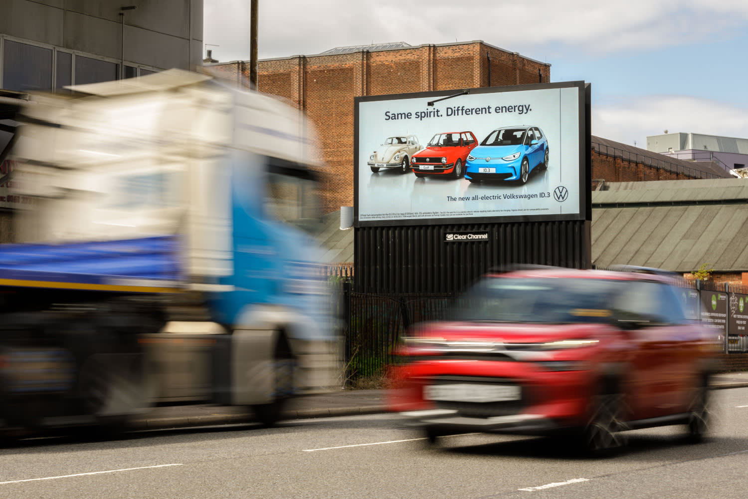 A VW digital billboard campaign with cars driving back in front