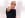 evan pointing at the camera in front of a white wall, wearing black rimmed glasses in his Paris selection t shirt