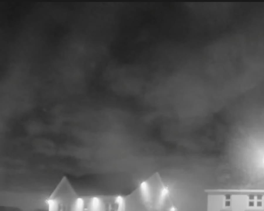 Nighttime clouds over the neighborhood houses with the very, *very* vague shape of a face in them.
