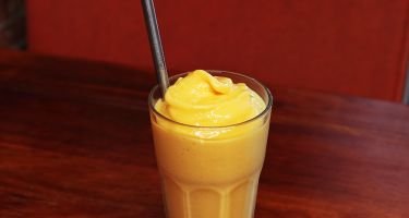 Mango lassi with a stainless steel straw
.