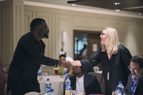 Paystack’s Head of Revenue - Hayley Hopwood shaking hands with an attendee at the Paystack Aviation Luncheon in Lagos, Nigeria.