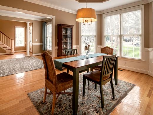 Four-seater dining table and chairs by a window