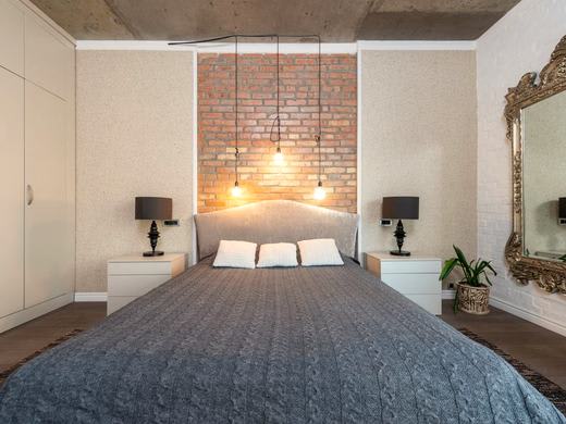 Queen bed with storage, lit by bedside lamps