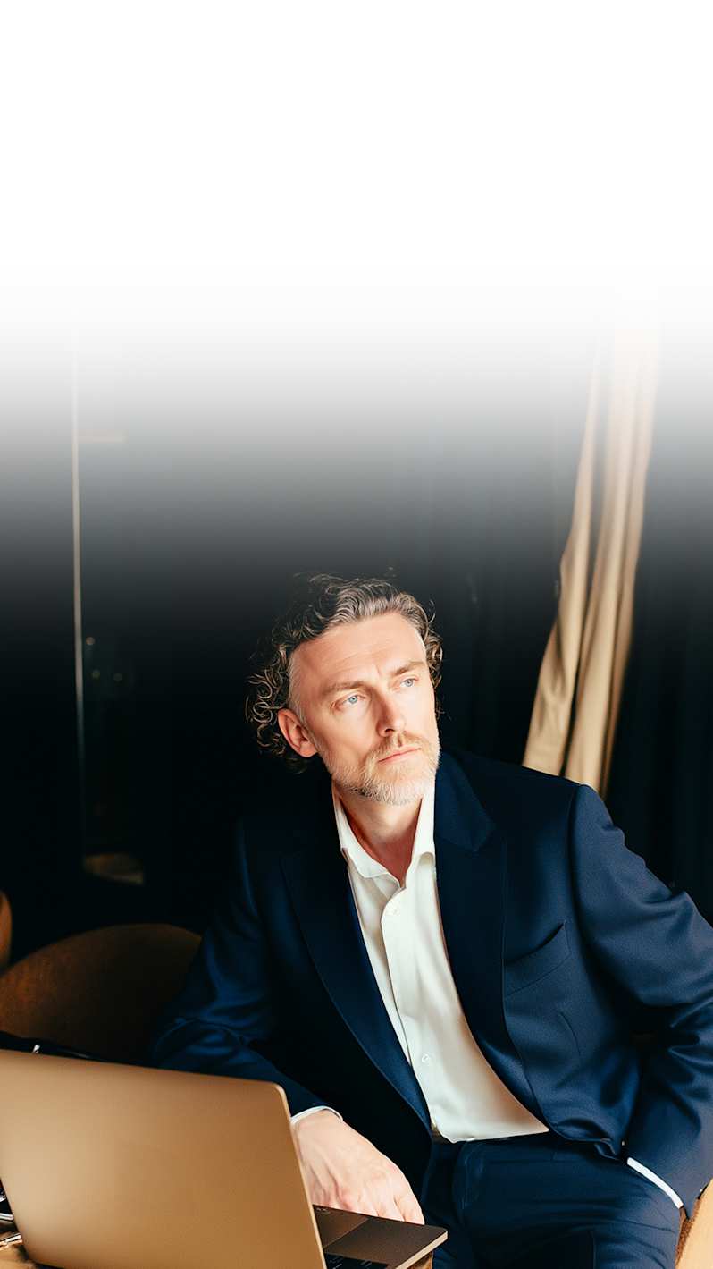 A businessman looks at the laptop