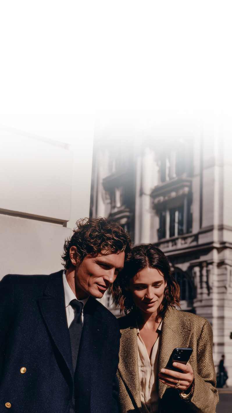 A man and a woman look at the mobile phone