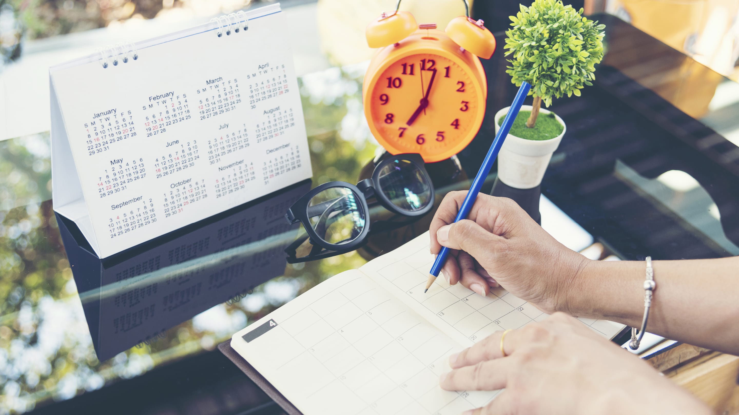 Desk with desk calendar and planner.