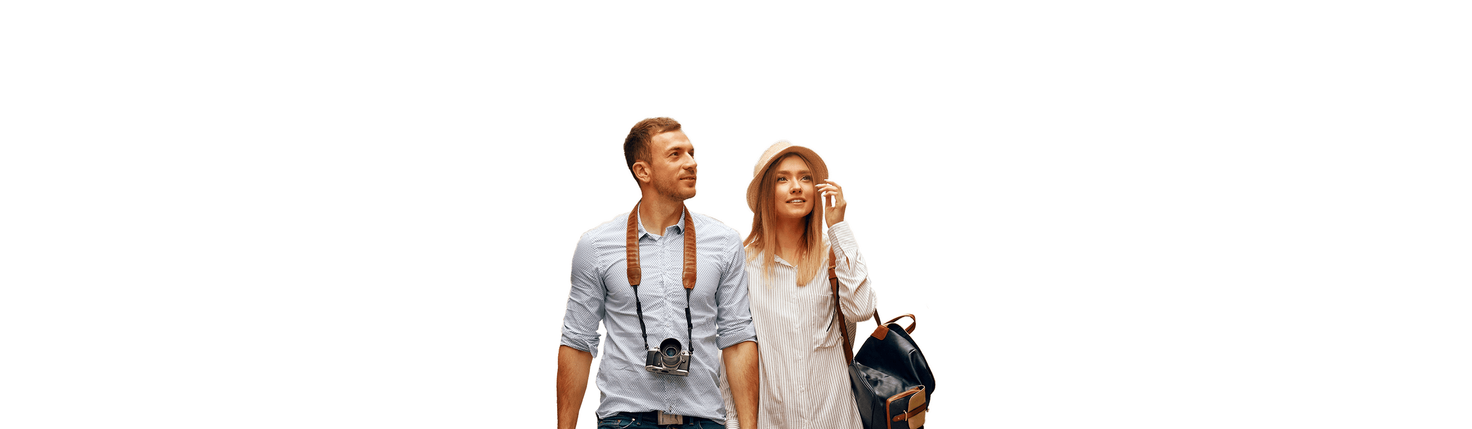 A young couple walks down the street holding hands.