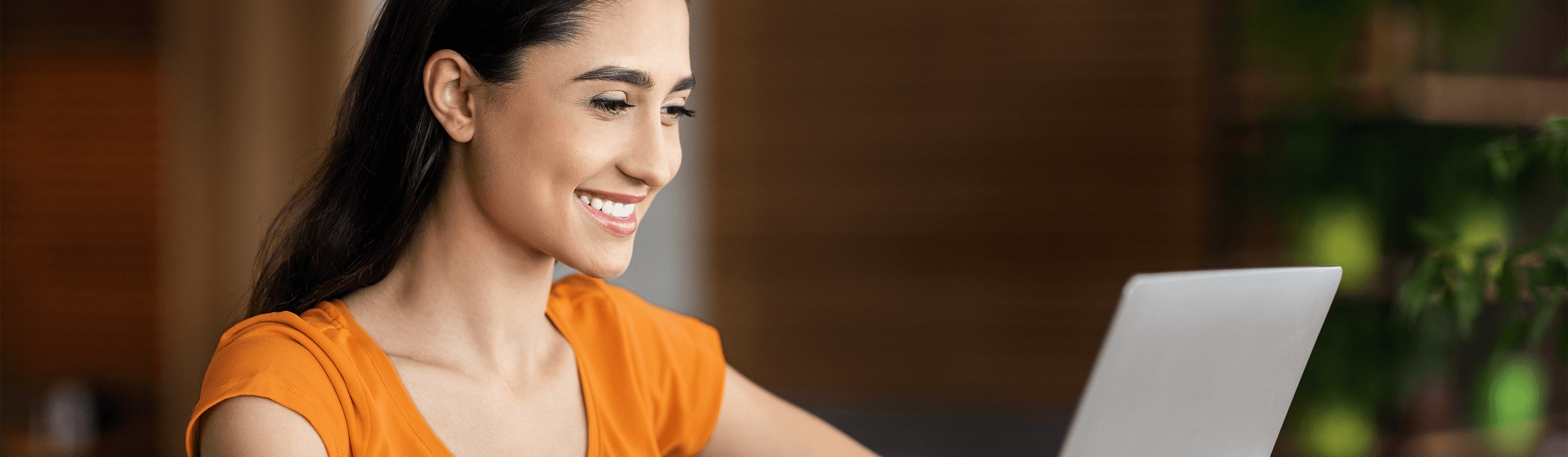 Smiling young woman with laptop.