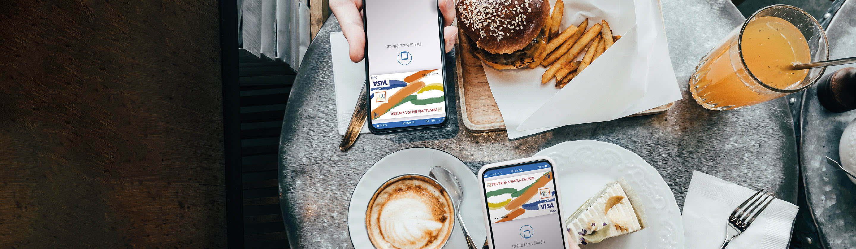 Along with food and drinks, there is a mobile phone on the table ready for contactless payment.