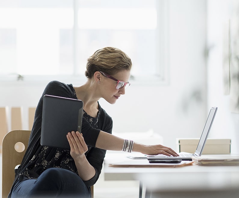 Woman with laptop and tablet.
