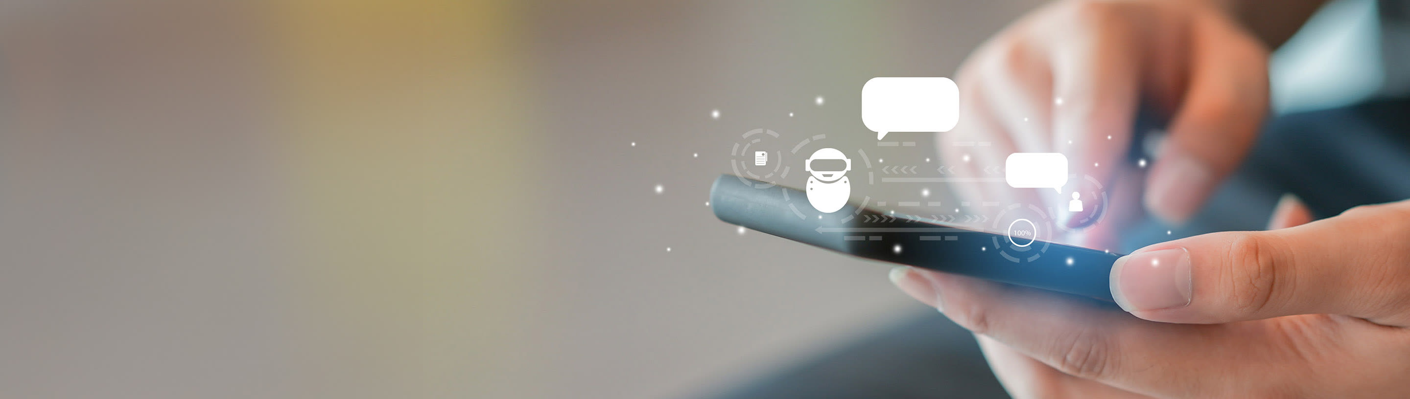 Mobitel u ruci iz kojeg ledbe ikonice robota.