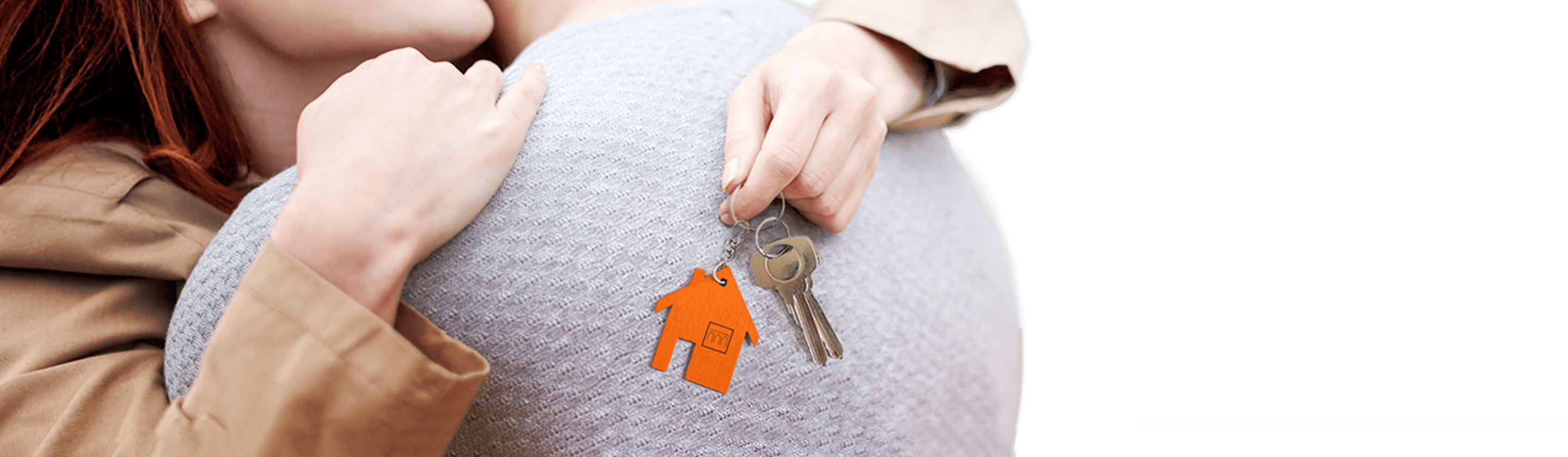 A woman in an embrace with a man holding the keys to the apartment in her hands.