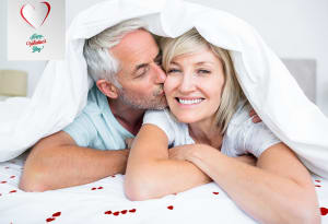 Man and woman kissing in bed