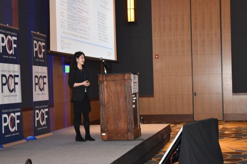 A woman presents on stage