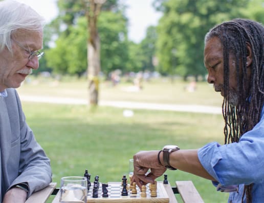 two mature men playing chess