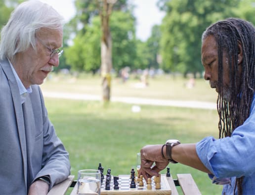 two mature men playing chess